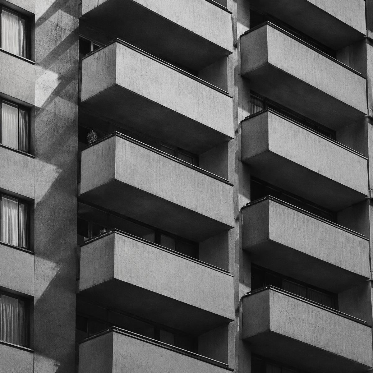 Apartment block facade with balconies, black and white photo